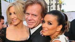 William H. Macy (1950-) con su esposa Felicity Huffman (1962-) y Eva Longoria (1975-) en 2016.jpg